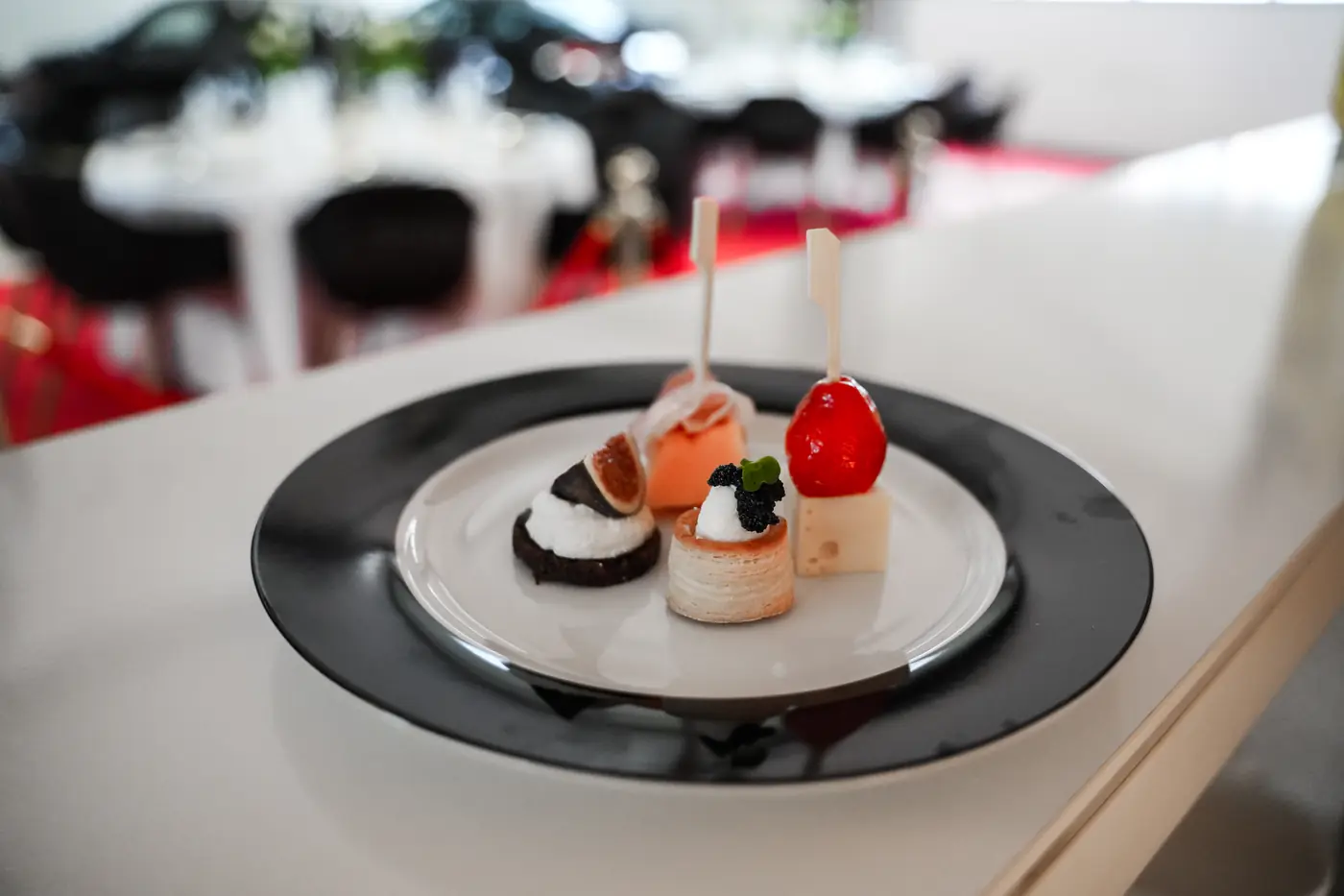 Kleines Dessert auf schwarzem Teller